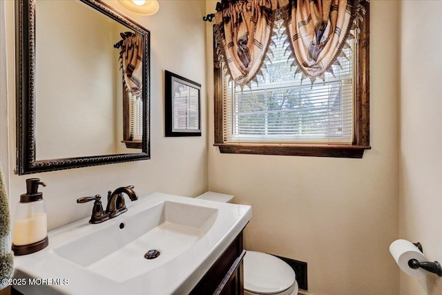 half bath with vanity and toilet