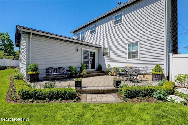 back of house featuring a patio, fence, and a yard