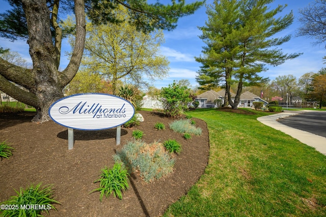 community sign featuring a lawn