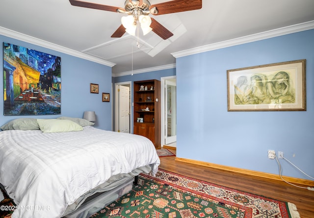 bedroom with ornamental molding, wood finished floors, baseboards, attic access, and ceiling fan
