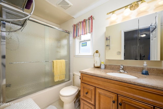 full bathroom featuring toilet, visible vents, shower / bath combination with glass door, and vanity