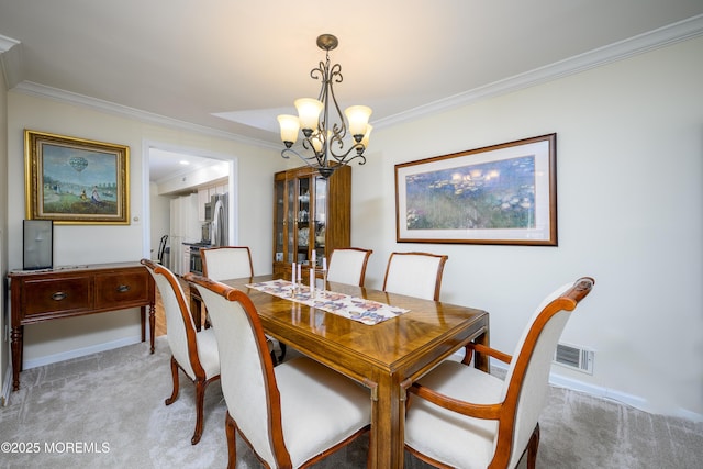 dining room with an inviting chandelier, ornamental molding, visible vents, and light carpet
