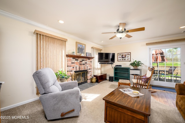 carpeted living room with a ceiling fan, a brick fireplace, baseboards, ornamental molding, and recessed lighting