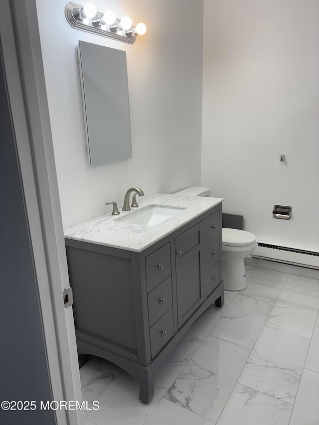 bathroom featuring toilet, marble finish floor, baseboard heating, and vanity
