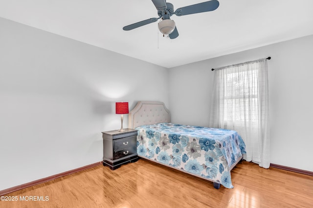 bedroom with baseboards, wood finished floors, and a ceiling fan