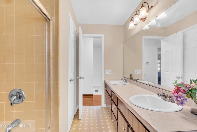 full bath with double vanity, a shower, and a sink