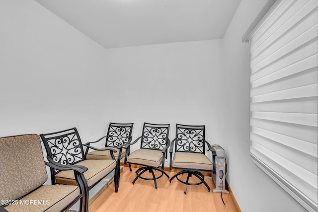 living area with baseboards and light wood-style flooring