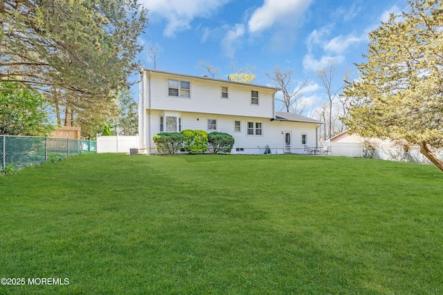 back of property featuring a lawn and a fenced backyard