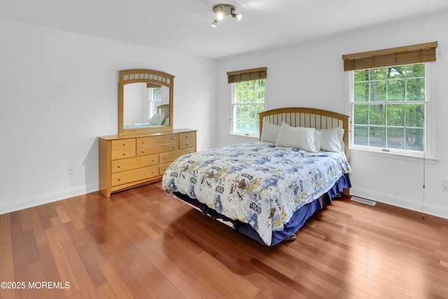 105 Tallwood Ln, Lincroft, NJ 07738 - bedroom featuring visible vents, multiple windows, and hardwood / wood-style floors