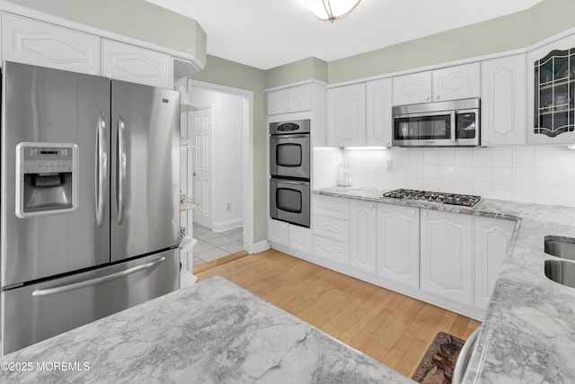 105 Tallwood Ln, Lincroft, NJ 07738 - kitchen with appliances with stainless steel finishes, light stone counters, and white cabinetry
