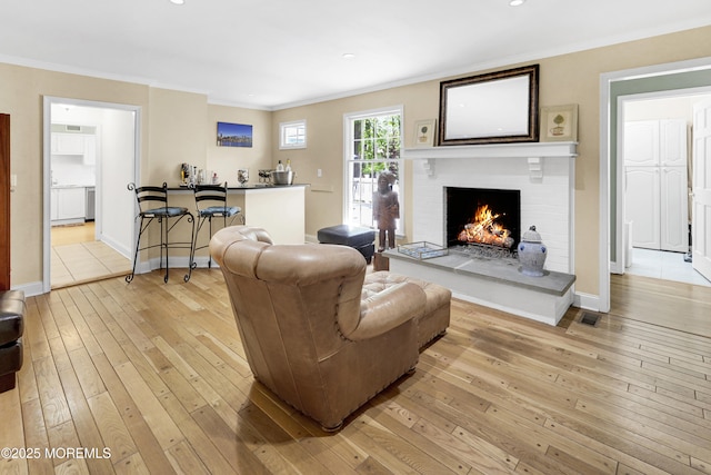 105 Tallwood Ln, Lincroft, NJ 07738 - living area with recessed lighting, ornamental molding, light wood-style flooring, and a fireplace