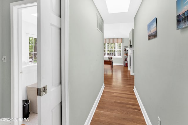 105 Tallwood Ln, Lincroft, NJ 07738 - corridor featuring baseboards, a skylight, visible vents, and wood finished floors