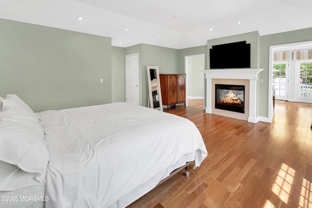 105 Tallwood Ln, Lincroft, NJ 07738 - bedroom featuring recessed lighting, a glass covered fireplace, and wood finished floors