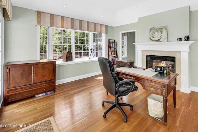 105 Tallwood Ln, Lincroft, NJ 07738 - home office featuring baseboards, a glass covered fireplace, a wealth of natural light, and wood finished floors
