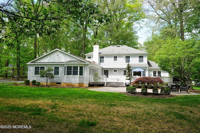 105 Tallwood Ln, Lincroft, NJ 07738 - back of property featuring a yard, a chimney, and a wooden deck