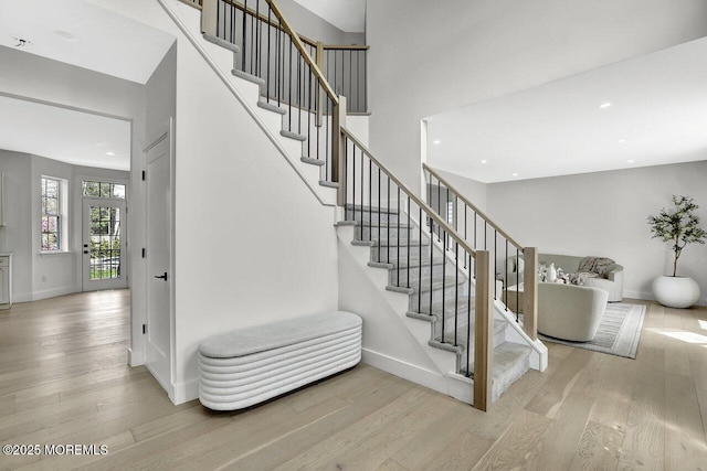 stairs with baseboards, recessed lighting, and wood finished floors