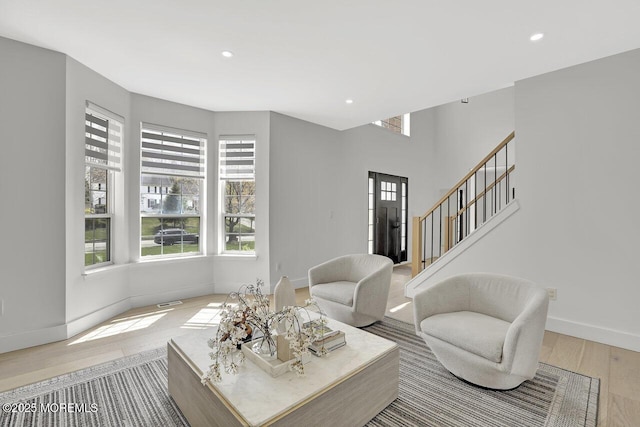 living room featuring baseboards, plenty of natural light, and wood finished floors