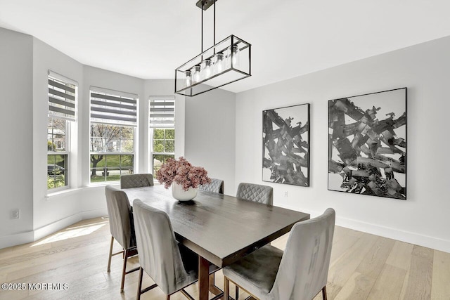 dining room with baseboards and light wood-style flooring
