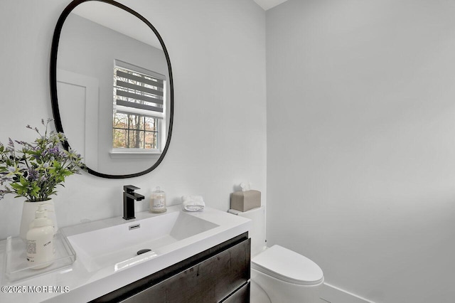 bathroom with vanity and toilet