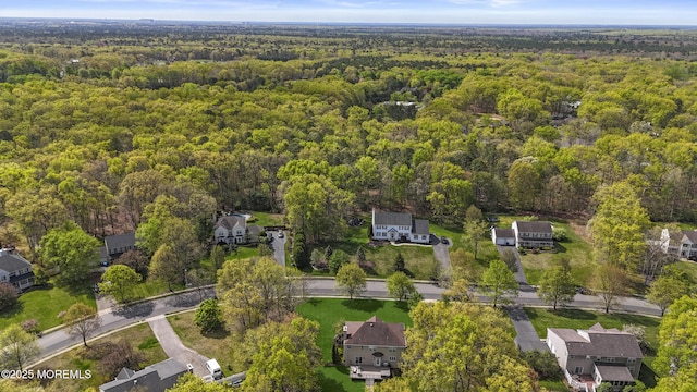 bird's eye view featuring a wooded view
