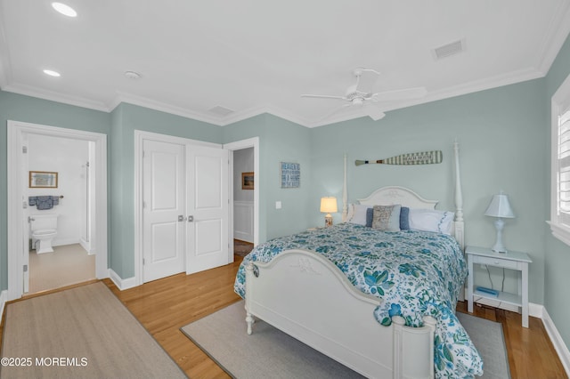 bedroom featuring a closet, recessed lighting, baseboards, and wood finished floors