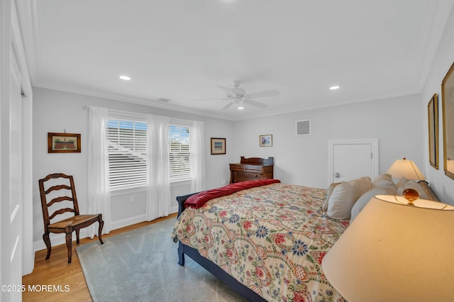 bedroom featuring light wood-style floors, recessed lighting, crown molding, and visible vents