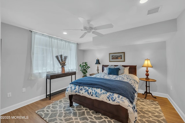 bedroom with visible vents, recessed lighting, baseboards, and wood finished floors