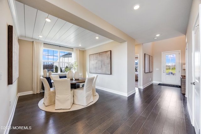 dining space with crown molding, a wealth of natural light, baseboards, and dark wood finished floors