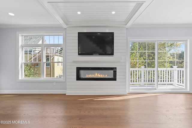 unfurnished living room featuring crown molding, wood finished floors, a large fireplace, baseboards, and recessed lighting