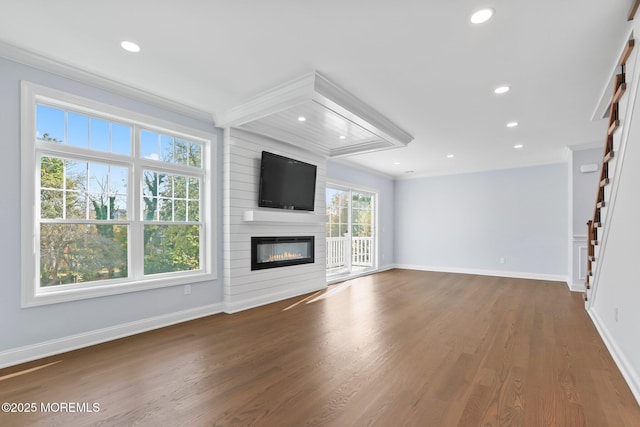 unfurnished living room featuring recessed lighting, baseboards, wood finished floors, and a fireplace