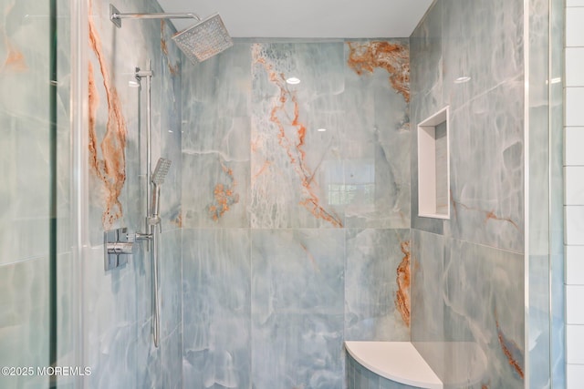 full bath featuring a marble finish shower
