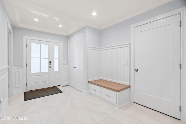 mudroom featuring wainscoting, recessed lighting, ornamental molding, and a decorative wall