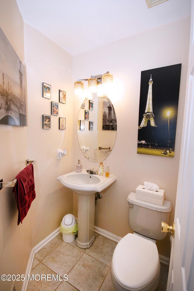 83 Nathan Blvd Unit 35, Sayreville, NJ 08859 - half bath featuring a sink, toilet, baseboards, and tile patterned floors