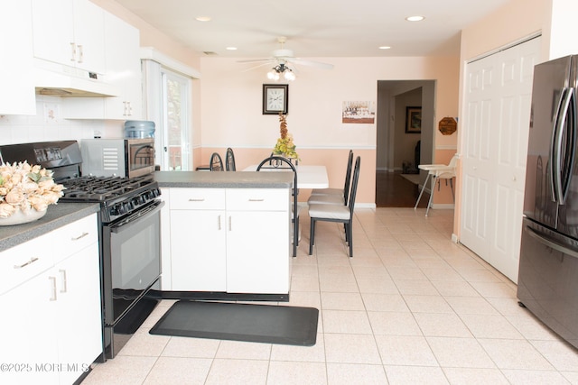 1150 Buckwald Ct, Lakewood, NJ 08701 - kitchen with freestanding refrigerator, under cabinet range hood, ceiling fan, black range with gas stovetop, and a peninsula