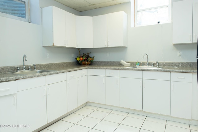 1150 Buckwald Ct, Lakewood, NJ 08701 - kitchen with light tile patterned flooring, a sink, and white cabinetry