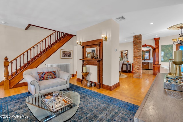 44 Irving Pl, Red Bank, NJ 07701 - living area featuring visible vents, decorative columns, wood finished floors, and radiator