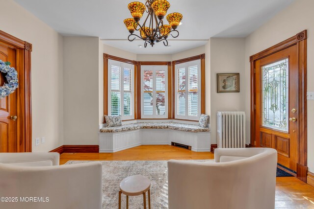 44 Irving Pl, Red Bank, NJ 07701 - sitting room featuring radiator, an inviting chandelier, light wood-style floors, and plenty of natural light