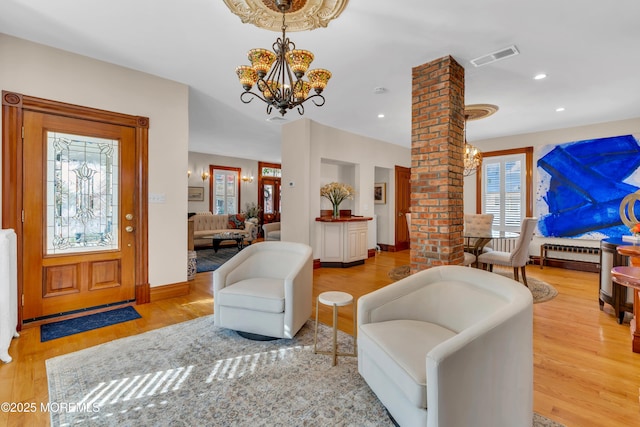 44 Irving Pl, Red Bank, NJ 07701 - living room featuring a chandelier, wood finished floors, a wealth of natural light, and ornate columns