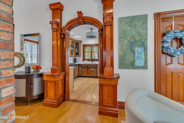 44 Irving Pl, Red Bank, NJ 07701 - hallway featuring light wood-style flooring, a sink, and decorative columns