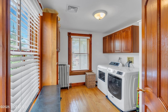 44 Irving Pl, Red Bank, NJ 07701 - laundry room featuring separate washer and dryer, light wood-type flooring, cabinet space, radiator, and visible vents