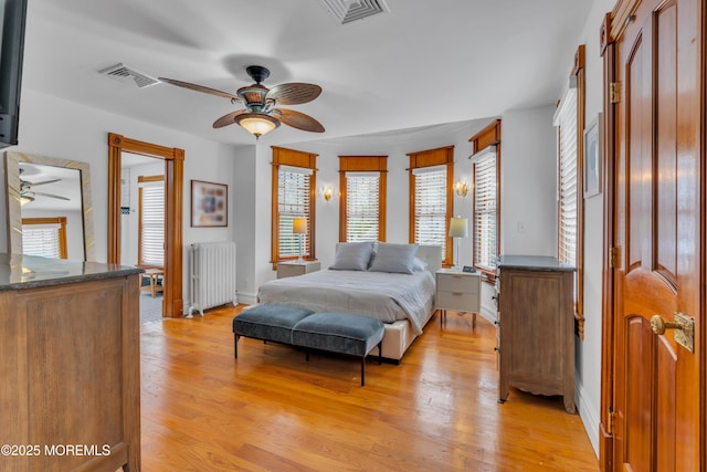 44 Irving Pl, Red Bank, NJ 07701 - bedroom with multiple windows, radiator heating unit, visible vents, and light wood-type flooring