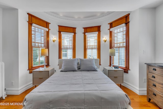 44 Irving Pl, Red Bank, NJ 07701 - bedroom with baseboards, light wood-style floors, ornamental molding, and a tray ceiling