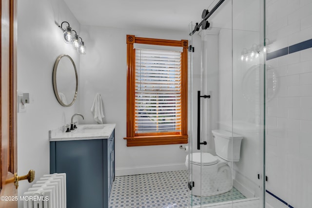 44 Irving Pl, Red Bank, NJ 07701 - bathroom featuring radiator heating unit, tile patterned floors, a stall shower, vanity, and toilet