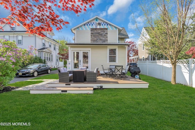 44 Irving Pl, Red Bank, NJ 07701 - rear view of house with french doors, fence, a lawn, a deck, and outdoor dining space