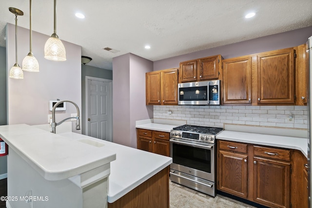 26 Dogwood Dr, Barnegat, NJ 08005 - kitchen with stainless steel appliances, a sink, tasteful backsplash, light countertops, and pendant lighting