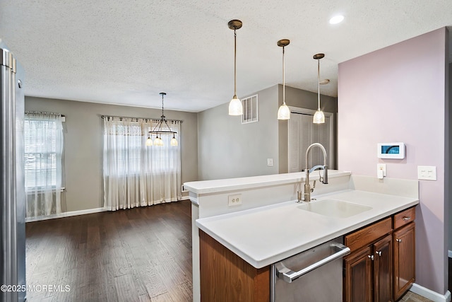 26 Dogwood Dr, Barnegat, NJ 08005 - kitchen featuring a sink, stainless steel dishwasher, plenty of natural light, dark wood-type flooring, and a textured ceiling