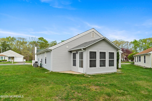 26 Dogwood Dr, Barnegat, NJ 08005 - rear view of property featuring a lawn and central air condition unit
