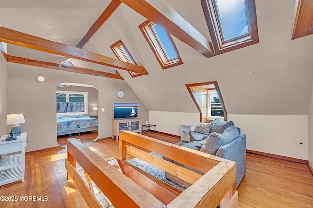 316 Rte 37, Seaside Heights, NJ 08751 - bedroom with baseboards, arched walkways, vaulted ceiling with skylight, and light wood-type flooring