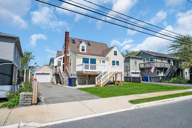 316 Rte 37, Seaside Heights, NJ 08751 - view of front of property featuring a front lawn, stairway, a residential view, a detached garage, and a chimney