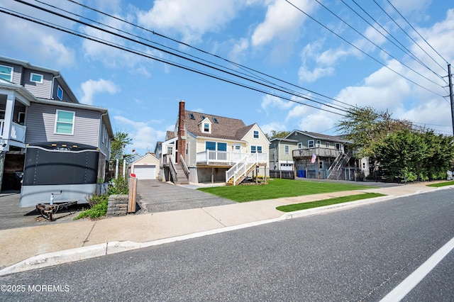 316 Rte 37, Seaside Heights, NJ 08751 - coastal home featuring stairway, a detached garage, aphalt driveway, and a residential view